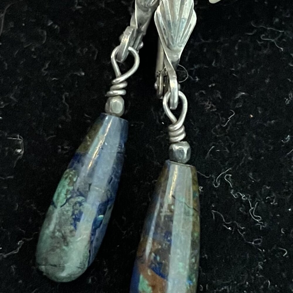silver and stone earrings with a shell design
